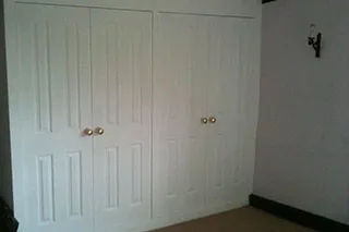 White fitted wardrobes with panelled doors